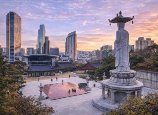 Korean Temples ① Bongeunsa Bongeunsa Temple courtyard and standing Buddha statue with the Gangnam skyline at sunset in Seoul